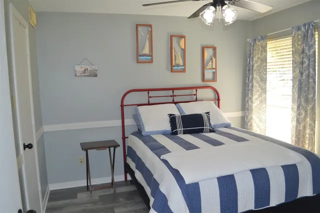 a bed sitting in a bedroom next to a window