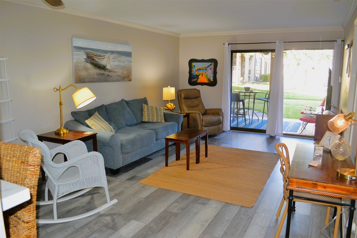 102 Lakeview Terrace, Unit D Conroe, TX 77356 - Photo 6 of 42 a living room with furniture and a floor to ceiling window