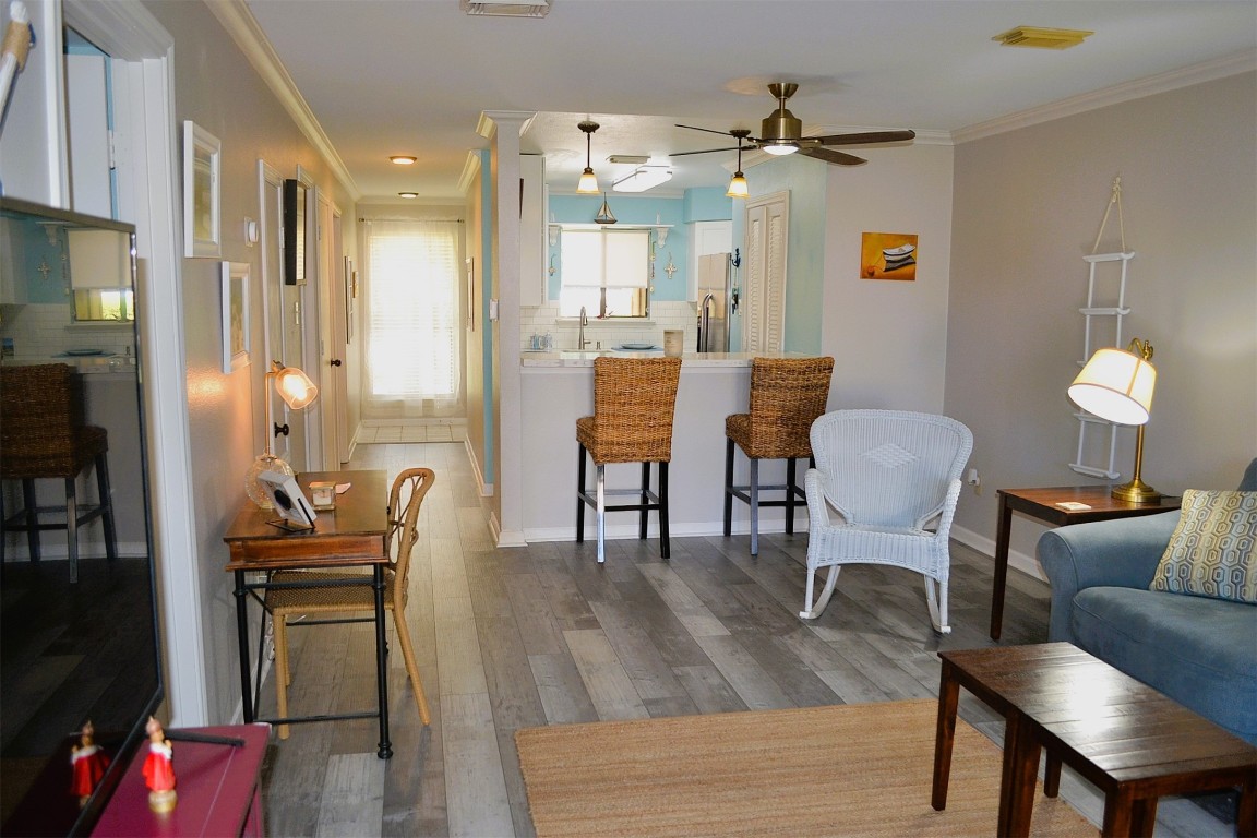 102 Lakeview Terrace, Unit D Conroe, TX 77356 - Photo 8 of 42 a view of a dining room with furniture and wooden floor