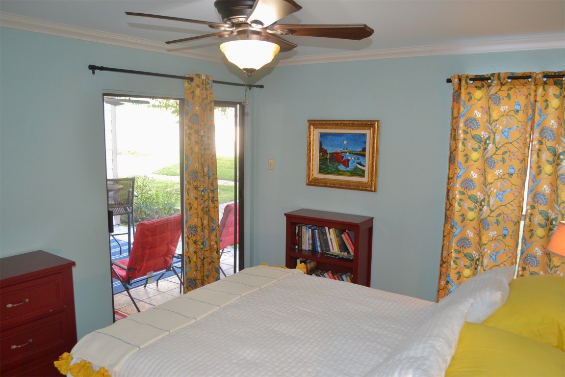 102 Lakeview Terrace, Unit D Conroe, TX 77356 - Photo 10 of 42 a bedroom with a bed and a dresser next to a window