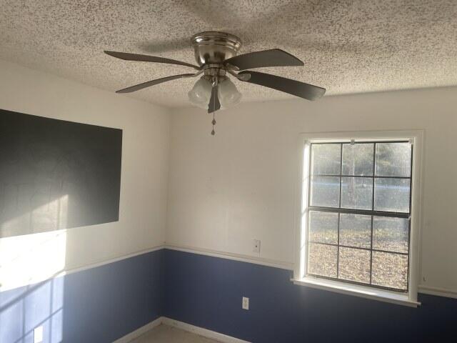 6047 Eden Square Crestview, FL 32539 - Photo 24 of 39 an empty room with windows and fan