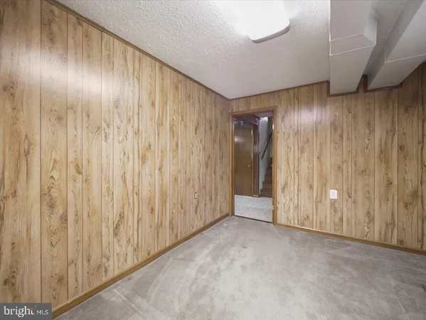 a view of an empty room with wooden walls