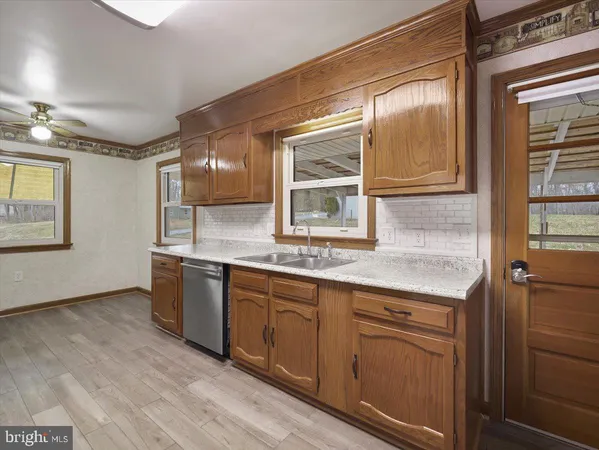 a kitchen with granite countertop a sink and cabinets