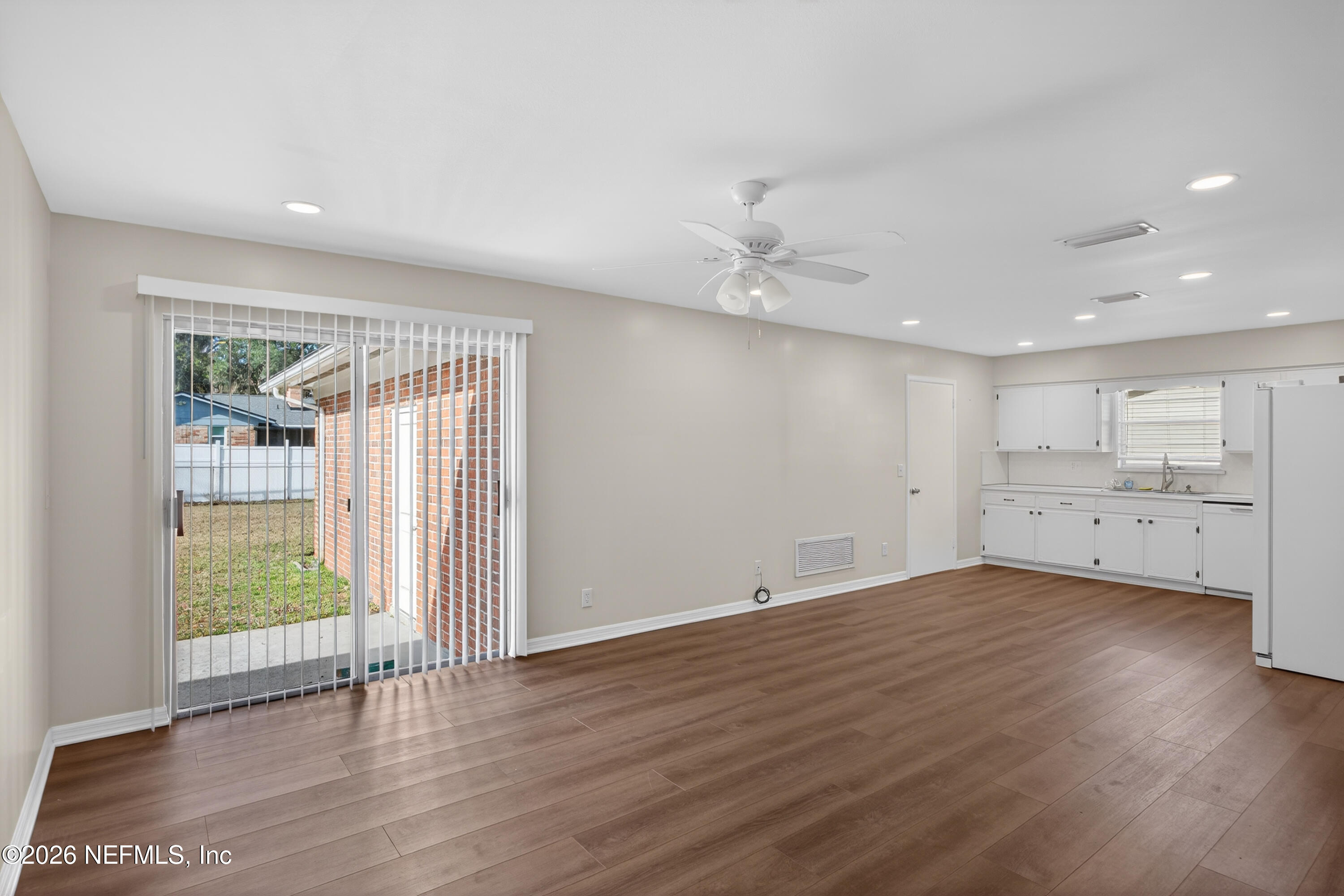 2766 Greenridge Road Orange Park, FL 32073 - Photo 13 of 30 a view of an empty room with wooden floor and a window