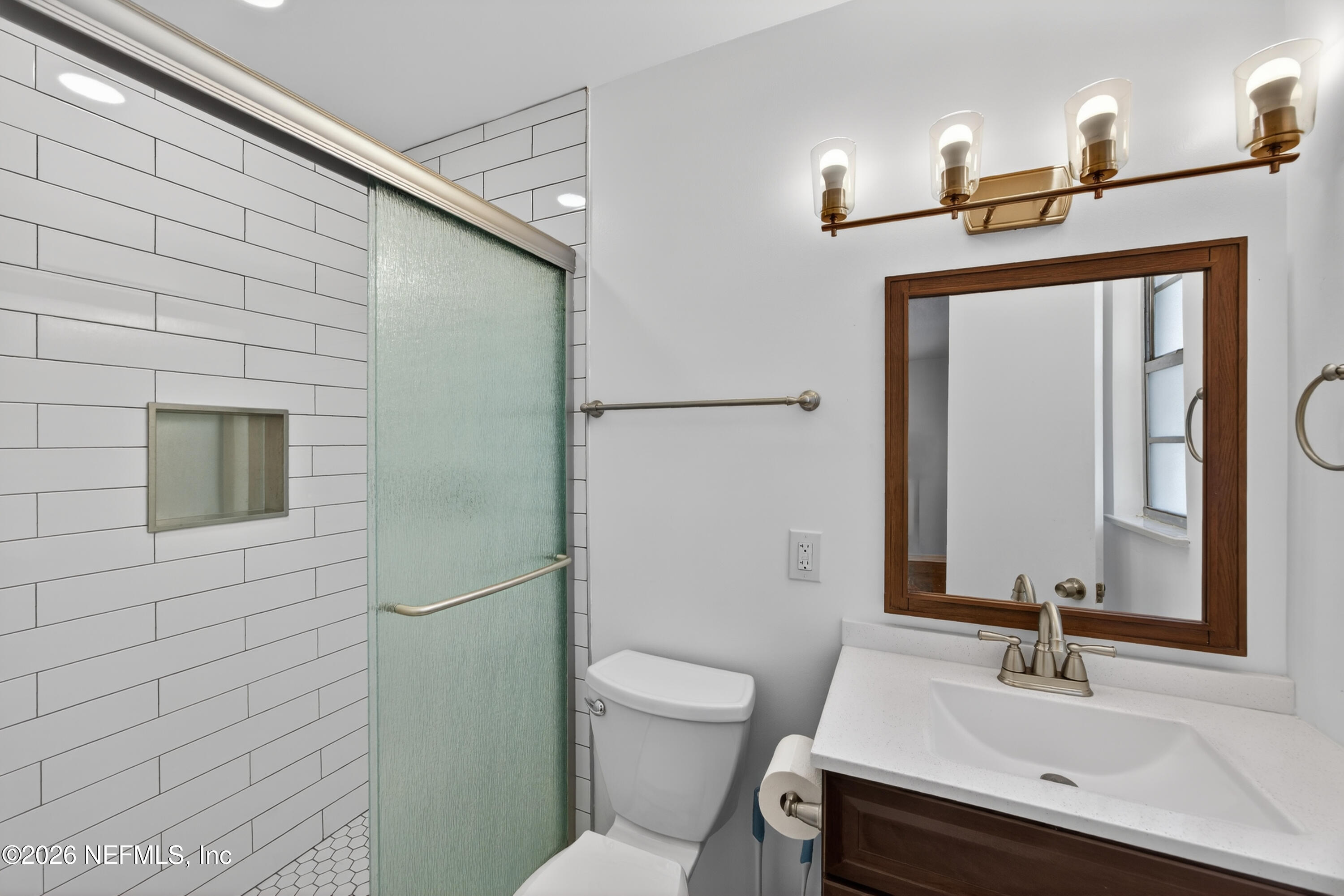 2766 Greenridge Road Orange Park, FL 32073 - Photo 17 of 30 a bathroom with a toilet sink and mirror