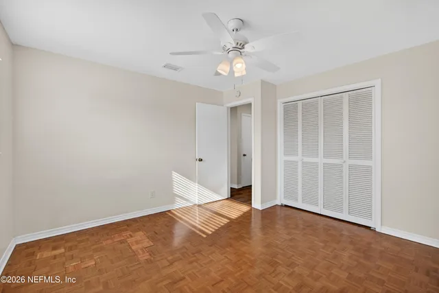 a view of an empty room with a fan