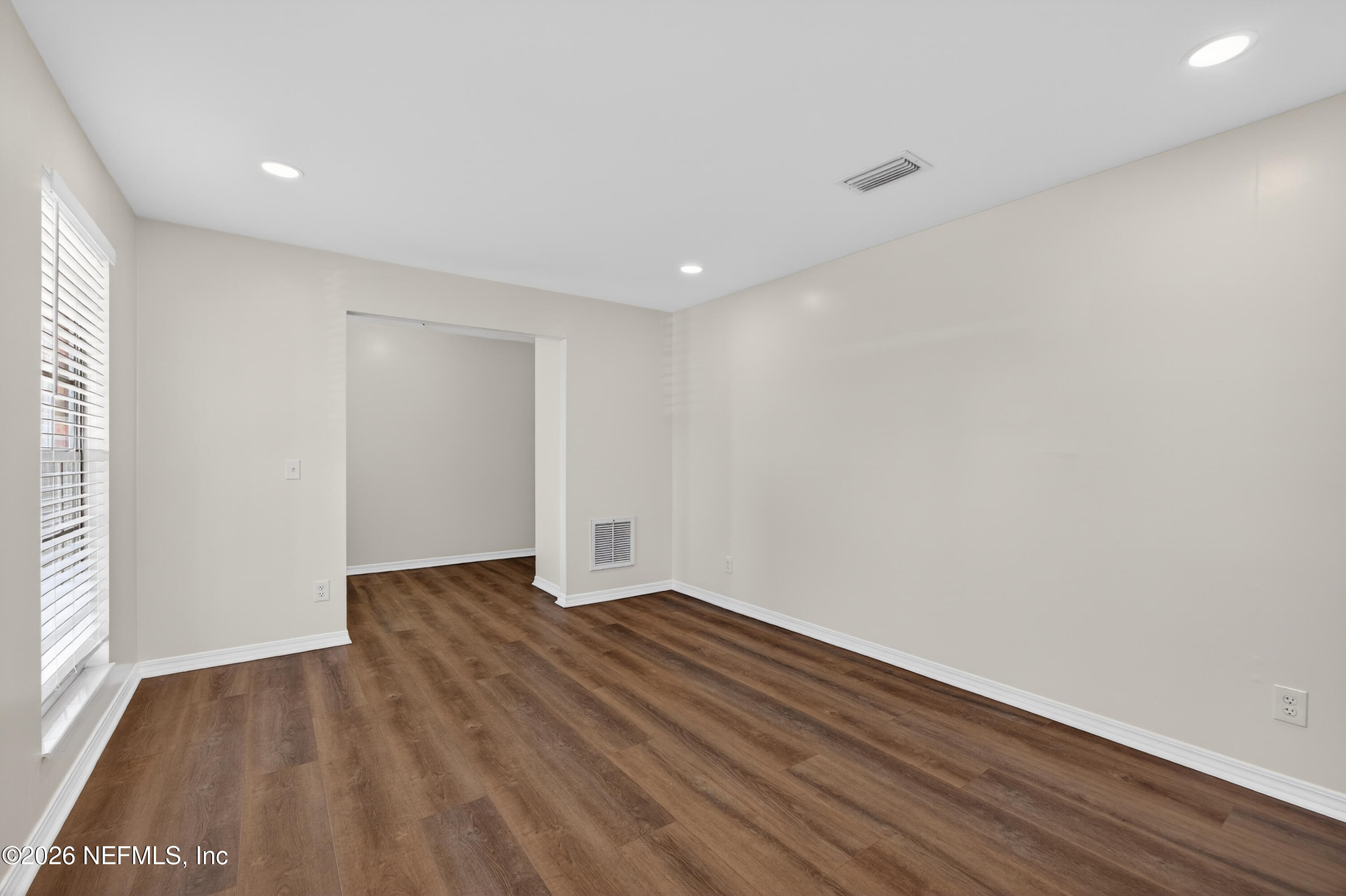 2766 Greenridge Road Orange Park, FL 32073 - Photo 6 of 30 a view of an empty room with wooden floor and a window