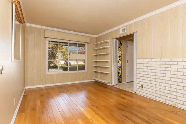 a view of wooden floor and windows in a room