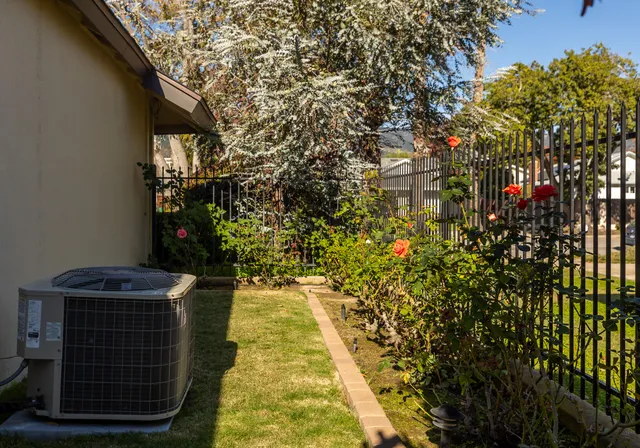 a backyard of a house with table and chairs