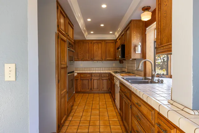a kitchen that has a sink and a stove in it