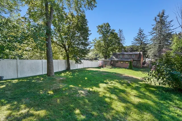 a backyard of a house with a garden and deck