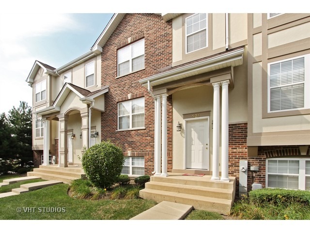 521 George Street, Unit 43 Wood Dale, IL 60191 - Photo 1 of 14 a view of a white house with a large windows and a dining table and chairs