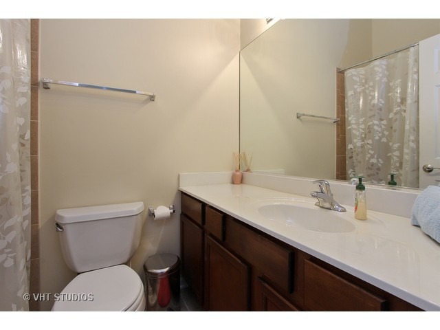 521 George Street, Unit 43 Wood Dale, IL 60191 - Photo 11 of 14 a bathroom with a toilet sink and mirror