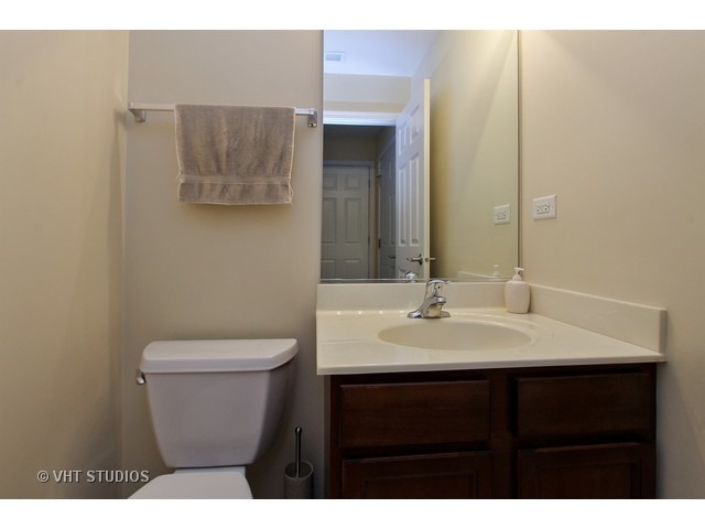 521 George Street, Unit 43 Wood Dale, IL 60191 - Photo 13 of 14 a bathroom with a toilet a sink and mirror