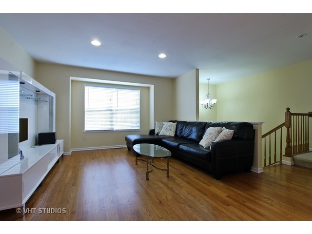 521 George Street, Unit 43 Wood Dale, IL 60191 - Photo 2 of 14 a living room with a couch and a flat screen tv