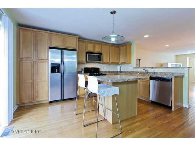 521 George Street, Unit 43 Wood Dale, IL 60191 - Photo 4 of 14 a kitchen with stainless steel appliances granite countertop a sink a stove a refrigerator cabinets and a dining table