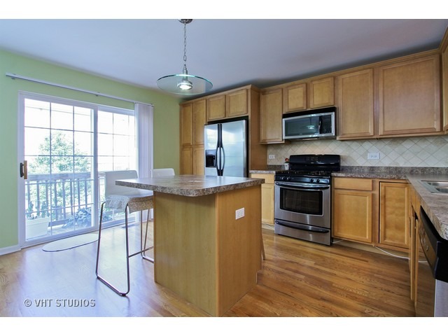 521 George Street, Unit 43 Wood Dale, IL 60191 - Photo 5 of 14 a kitchen with granite countertop wooden floors stove top oven and sink