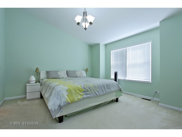 521 George Street, Unit 43 Wood Dale, IL 60191 - Photo 7 of 14 a bedroom with a bed chandelier and a window