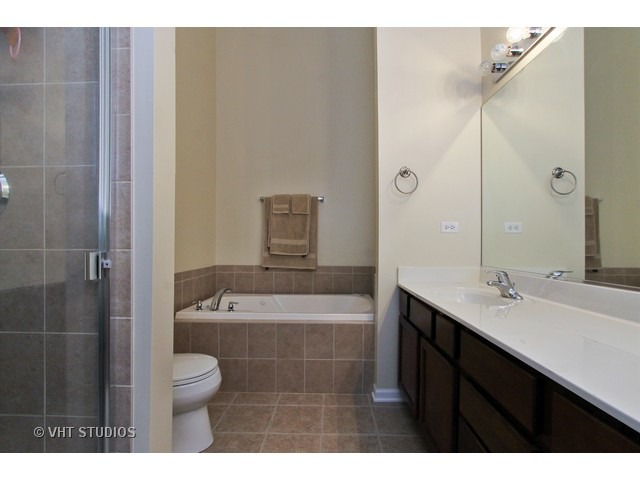 521 George Street, Unit 43 Wood Dale, IL 60191 - Photo 8 of 14 a bathroom with a sink a toilet and shower