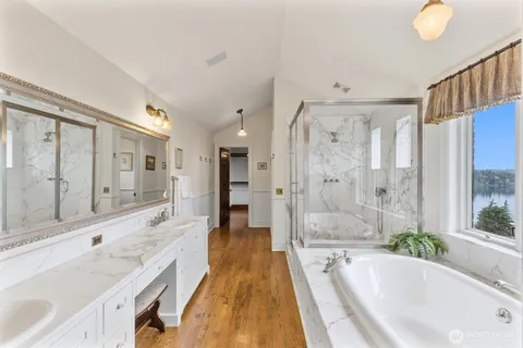 a spacious bathroom with a tub shower and sink