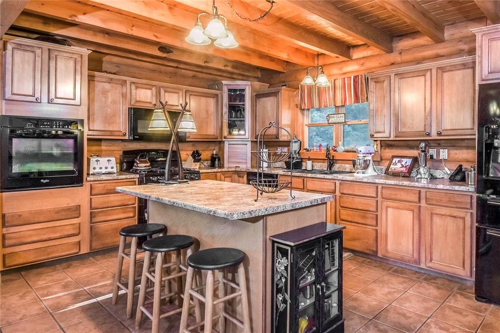 119 Kelly Road Washington, PA 15301 - Photo 2 of 25 If you love natural wood then you are going to love walking into this house! The Kitchen has ceramic tile flooring and there is a center island where you can put bar stools and sit for a quick lunch. The ceilings have wood beams that cross over the Kitchen and give the room the illusion of sitting under a shade tree. There is lighting above the island and above the sink to add a touch of class.