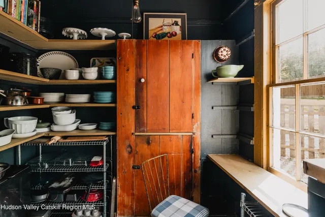 a kitchen with stainless steel appliances a sink a stove and a wooden floor