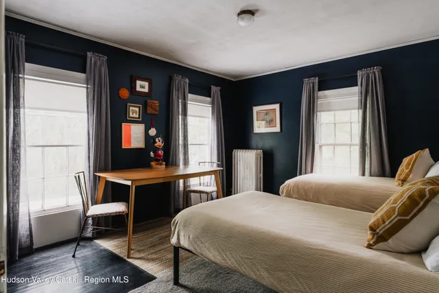 a bed room with a bed and a chair