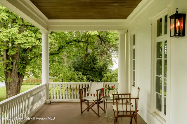 a view of a balcony with chair and floor to ceiling window