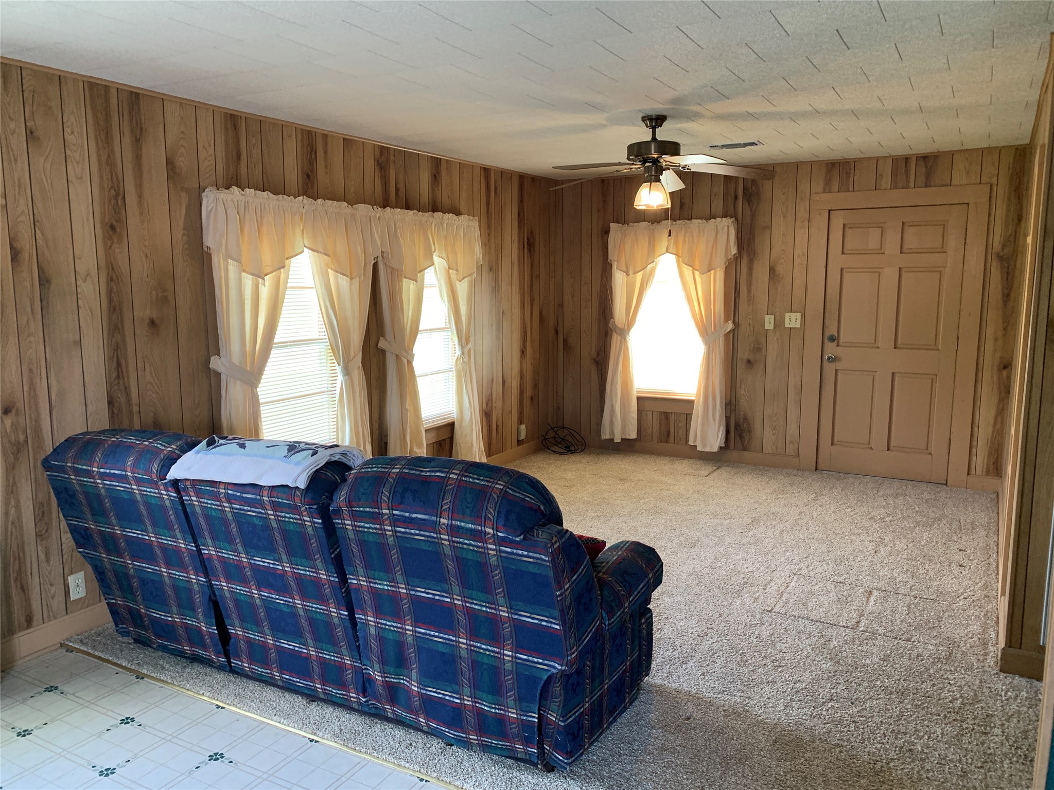 908 Paulus Street Schulenburg, TX 78956 - Photo 2 of 5 a spacious bedroom with a bed and a chandelier