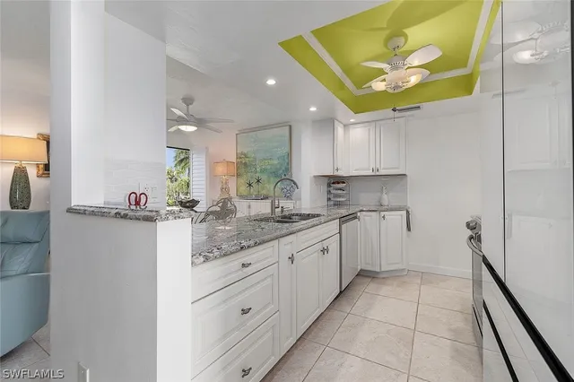 a kitchen with a sink cabinets and window