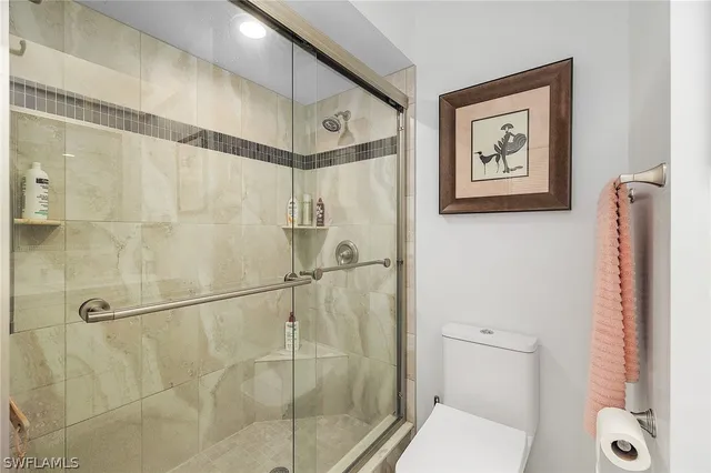 a bathroom with a shower and toilet