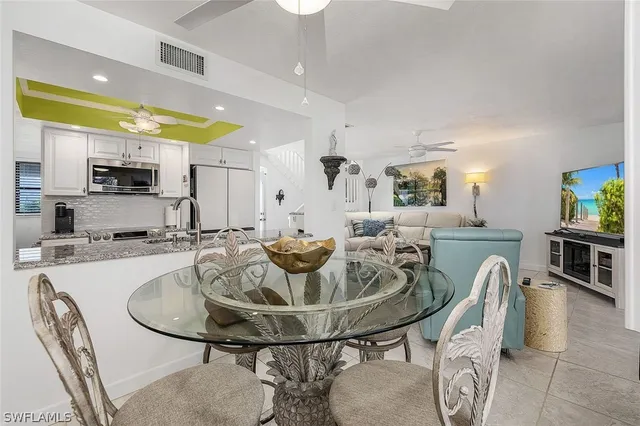 a view of a dining room with furniture and a kitchen