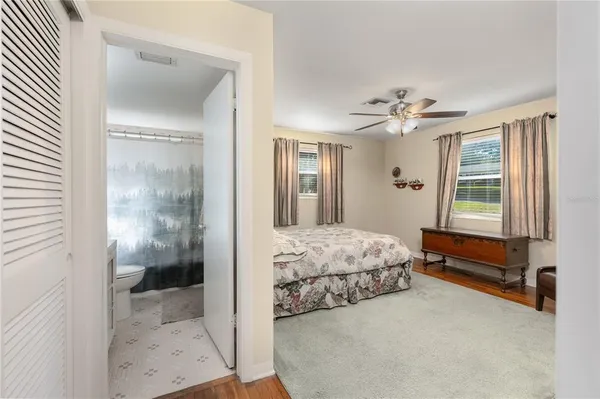 a bedroom with a bed and glass door