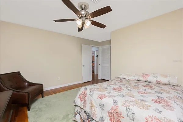 a bedroom with a bed and a chair