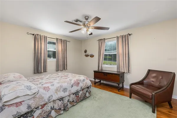 a bedroom with a bed couch and window