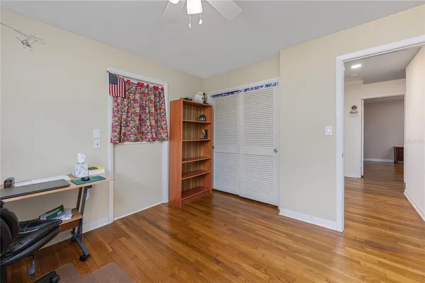 a view of room with wooden floor and closet