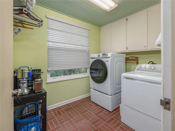 a utility room with sink dryer and washer