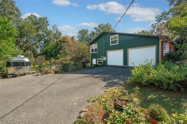 a front view of a house with a yard and a garage