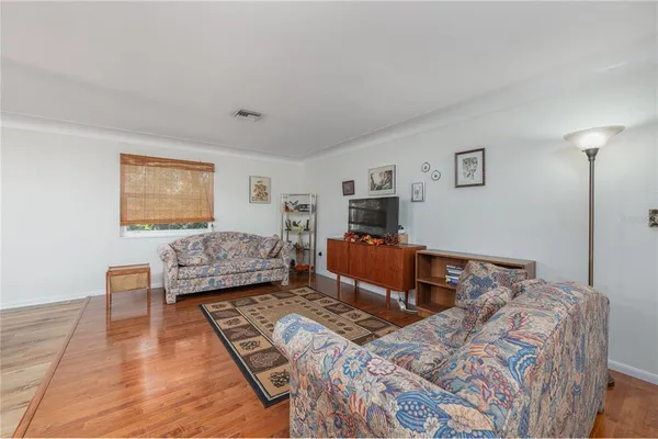 a bedroom with two bed and a flat screen tv