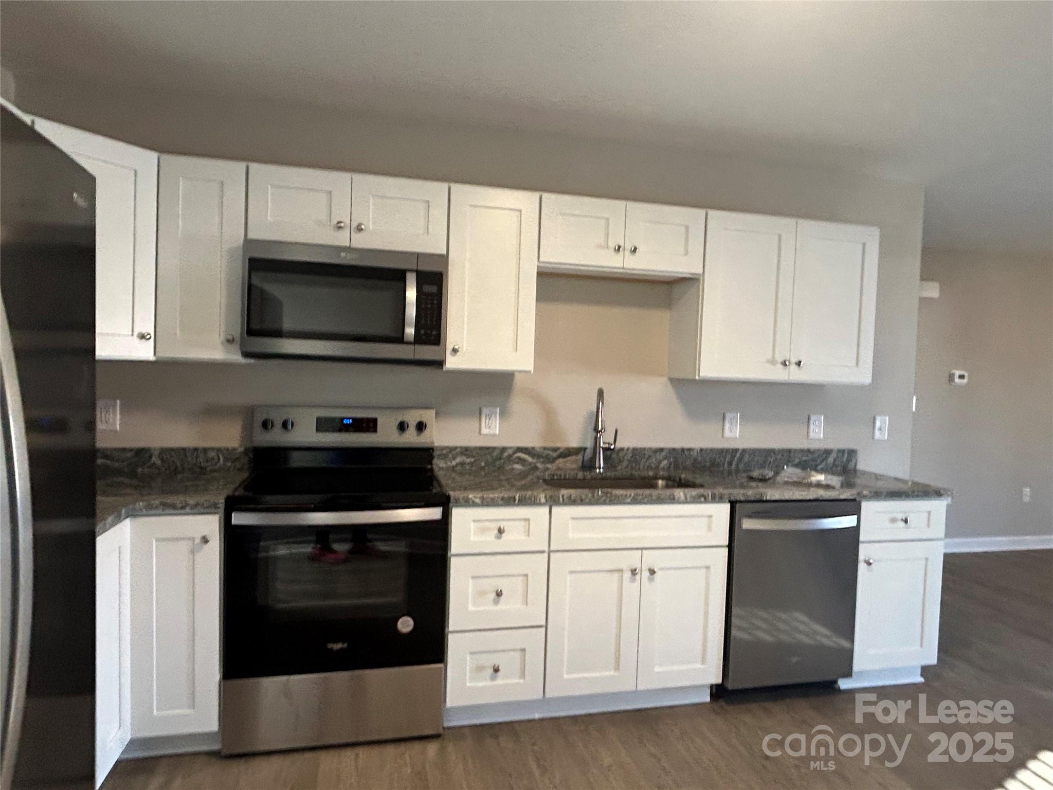 3301 Paul Elmore Road Lincolnton, NC 28092 - Photo 3 of 12 a kitchen with granite countertop white cabinets and stainless steel appliances