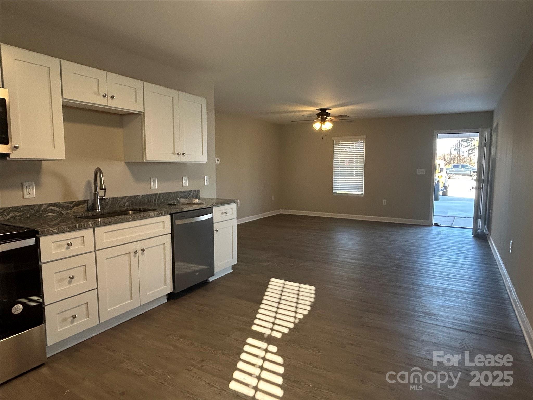 3301 Paul Elmore Road Lincolnton, NC 28092 - Photo 4 of 12 a kitchen with stainless steel appliances granite countertop a sink dishwasher a stove and a granite counter tops with wooden floors