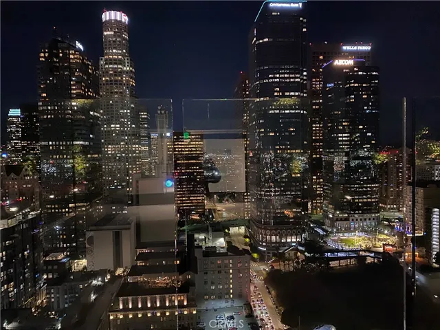a living room with furniture wooden floor and floor to ceiling windows