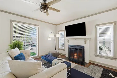 a living room with furniture a fireplace and a flat screen tv