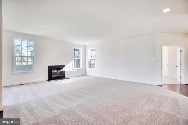 a view of an empty room with a fireplace