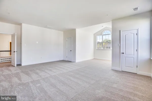 an empty room with windows and closet