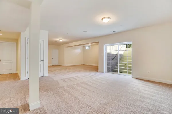 an empty room with windows and entrance