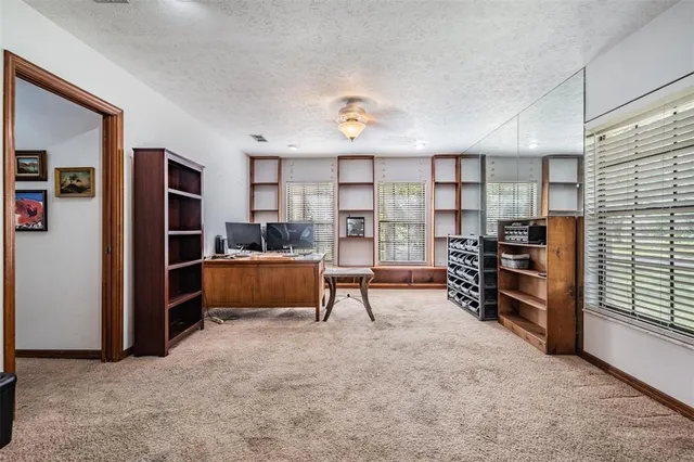 a bathroom with a granite countertop sink a mirror and a bathtub