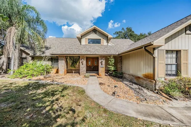 a front view of a house with a yard outdoor seating and garage