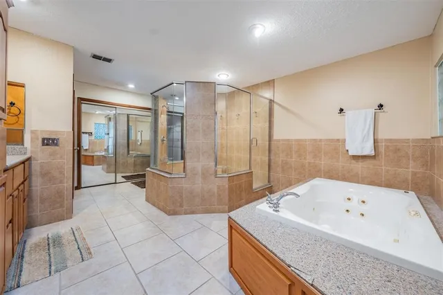 a bathroom with a granite countertop sink a toilet and a mirror