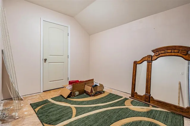 an aerial view of residential house with outdoor space and trees all around